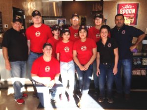 Franchisee Manuel Pizaño-Carlo (far right) poses with his team in front of the counter at the 100th Erbert & Gerbert’s location.