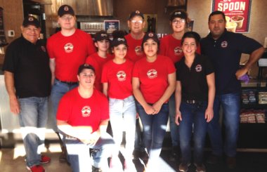 Franchisee Manuel Pizaño-Carlo (far right) poses with his team in front of the counter at the 100th Erbert & Gerbert’s location.